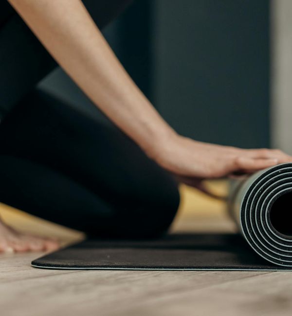 Smiling person meditating in a comfortable, relaxed position.